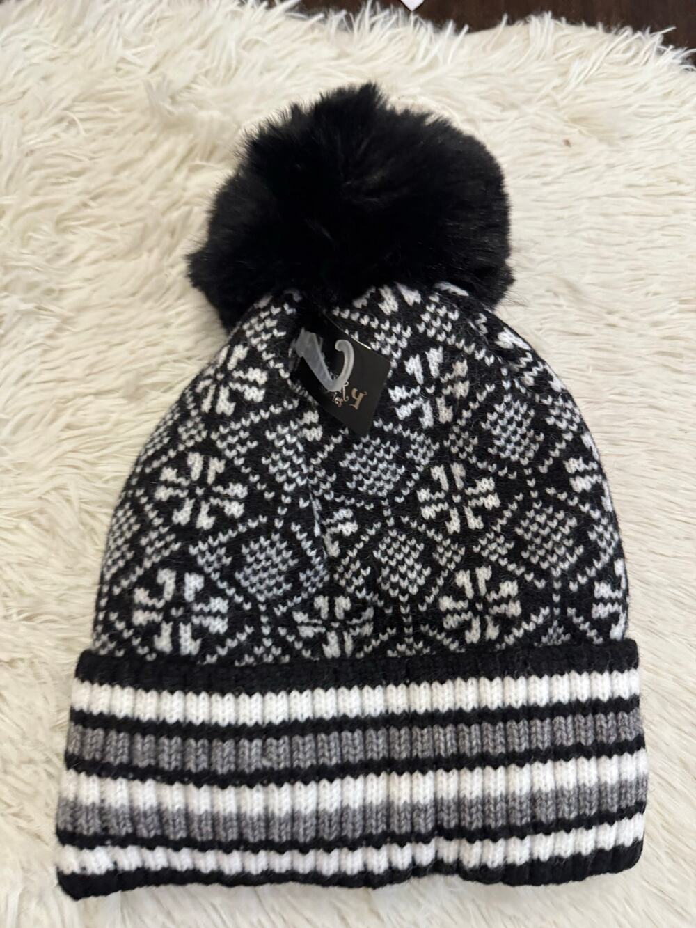 Black & white snowflake knit beanie with faux fur pom pom and fur lined